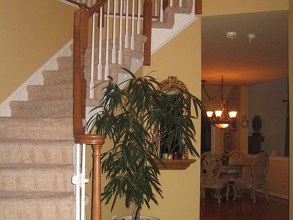 impressive two story foyer with turned staircase