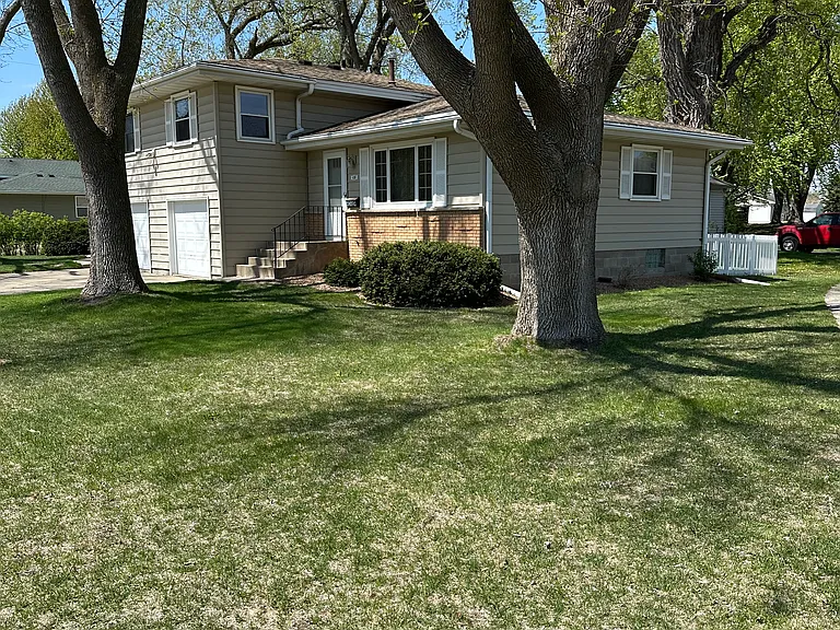 Well kept front yard with 3 beautiful trees