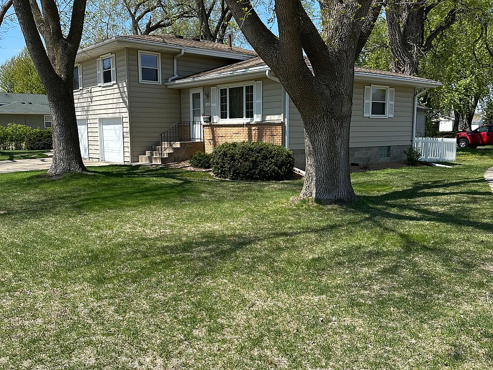 Well kept front yard with 3 beautiful trees