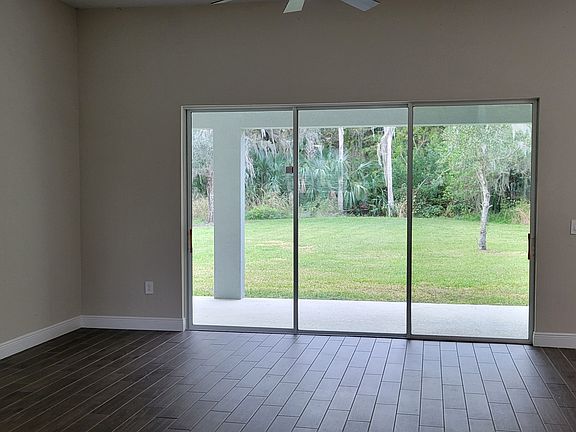 large living room with triple sliders