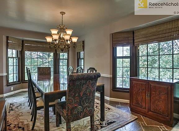Dine in the tree-tops! Gorgeous, tiled dining room with windows all around to capture nature's setting.