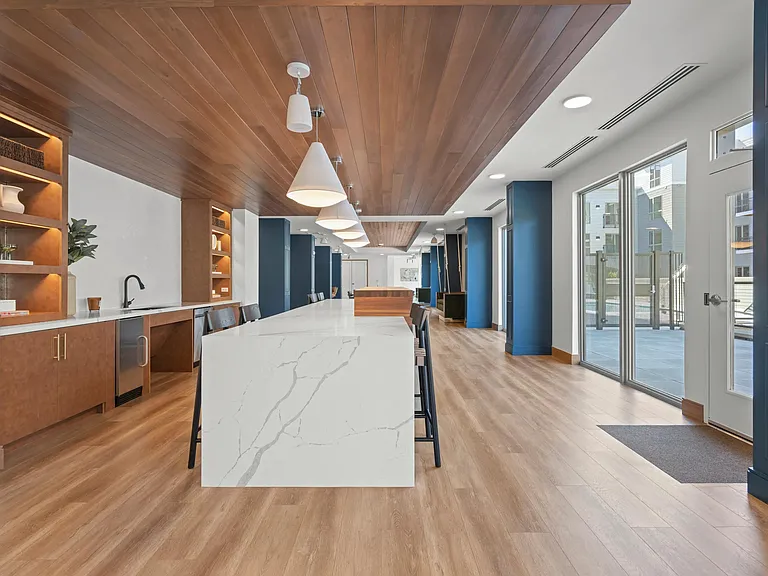 Expansive clubroom with gathering space and demonstration kitchen.