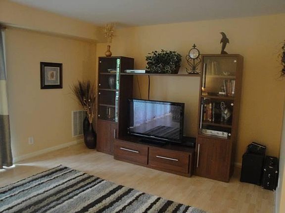 Large living room with space for bookshelves, TV, and more!