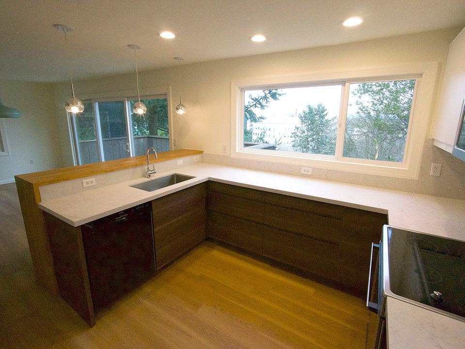 Chef's kitchen with breakfast bar, tons of counter space, great natural light, newer appliances including quiet dishwasher, and brand new cabinets and quartz counters. Full height cabinets (shown on plan) provide ample storage with a 36" wide fridge.