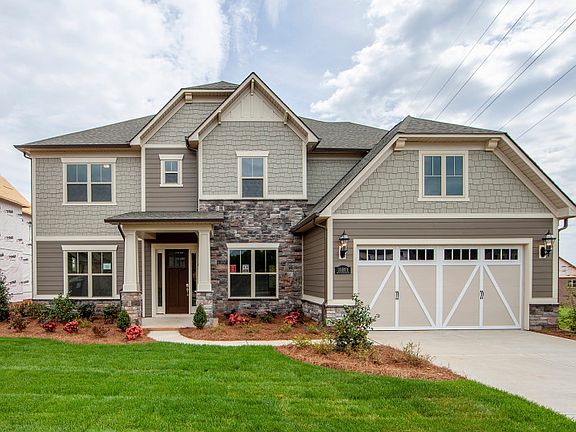 Worthington Exterior 3 features stone, siding, shakes, covered front door and 2 car front load garag