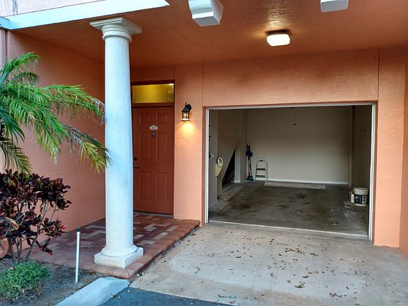 Garage Access. Building is now painted light blue. Interior entrance from garage access as well