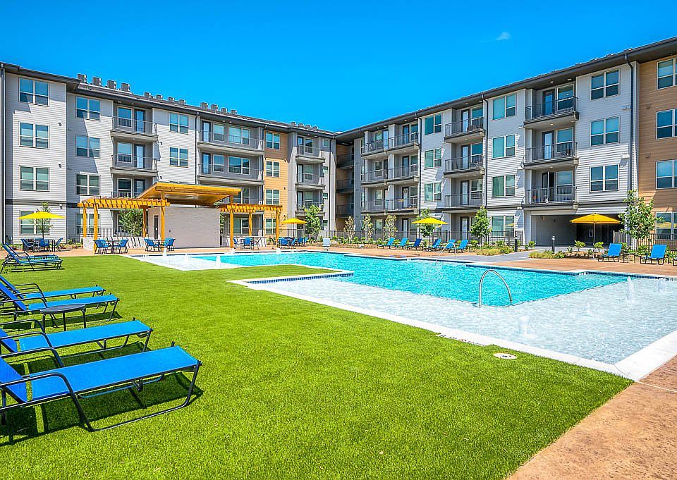 view of pool with a yard and a pergola