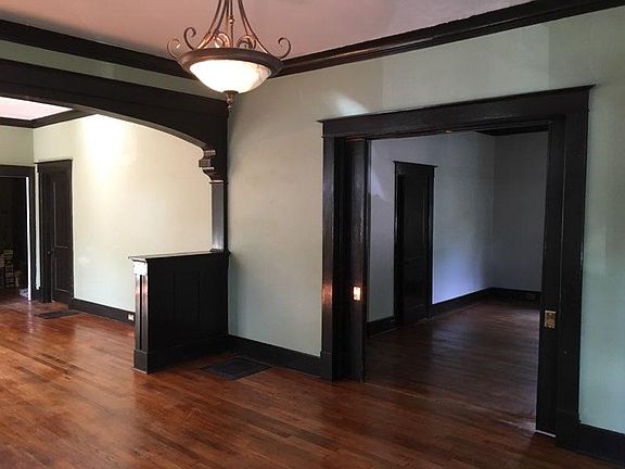 View through living room pocket doors into front bedroom.