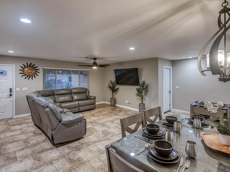 Bright and open living space with recessed lighting and ceiling fan for year-round comfort.