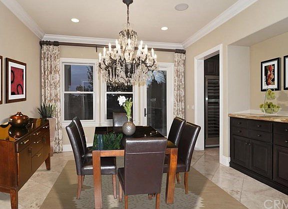 Large dining room with built-ins and view of side yard with built-in fountain