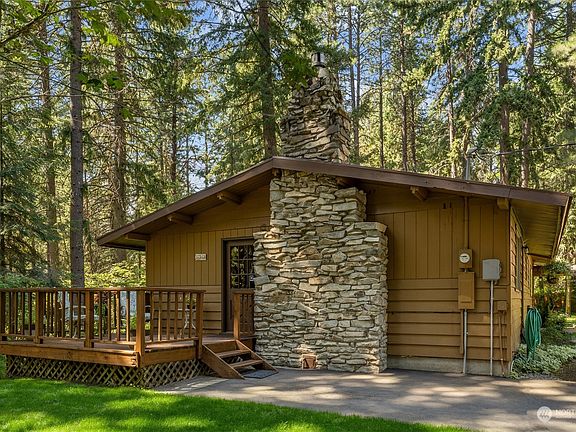 An additional deck with a side entrance highlights the stunning rock fireplace.>