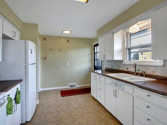 Kitchen is located next to the dining room. Just outside the door is your outdoor patio space perfec