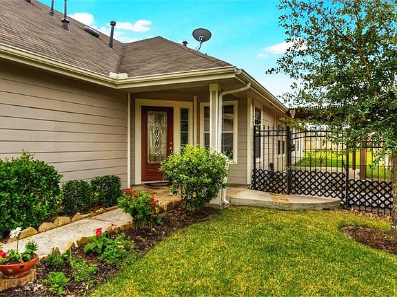 Beautiful landscaping and wrought iron fence make this home very inviting.