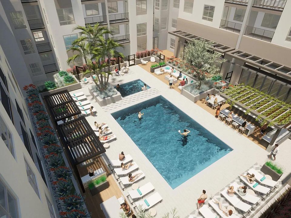 A sun-filled courtyard with a central pool, shaded lounge areas, and spaces designed for gathering.