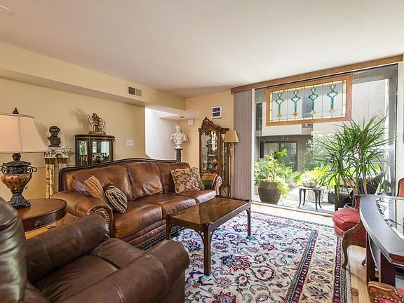Living Room looks out on to patio and lush private gated courtyard