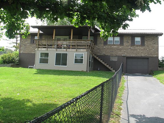 Deck overlooks backyard.