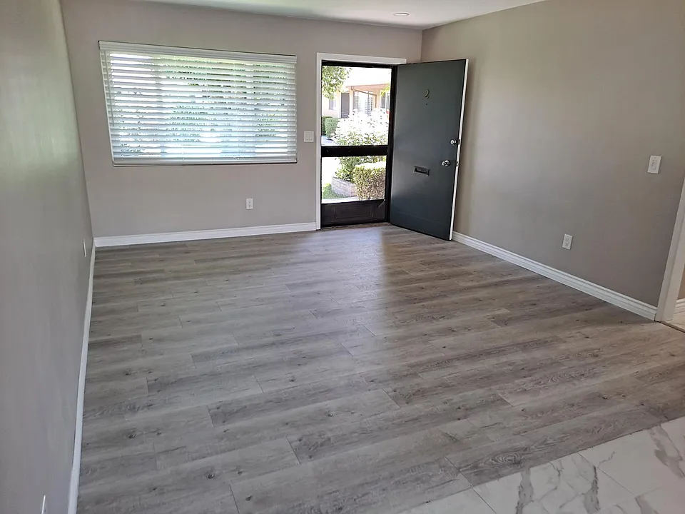 Living Room to front door and view of courtyard.