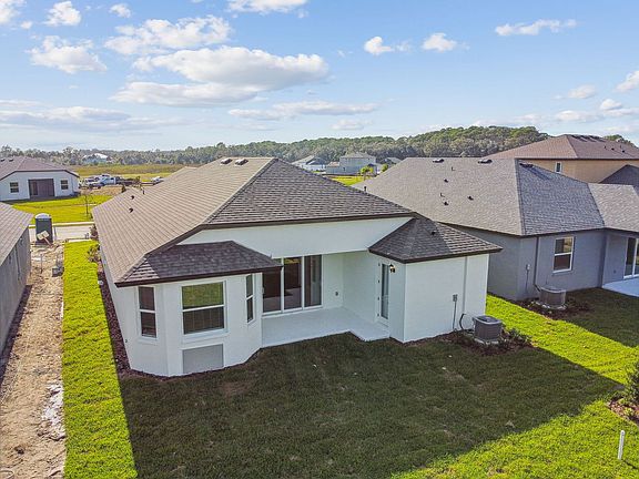 Sweetwater quick move-in new construction home plan elevated rear left view of home at Tea Olive Ter
