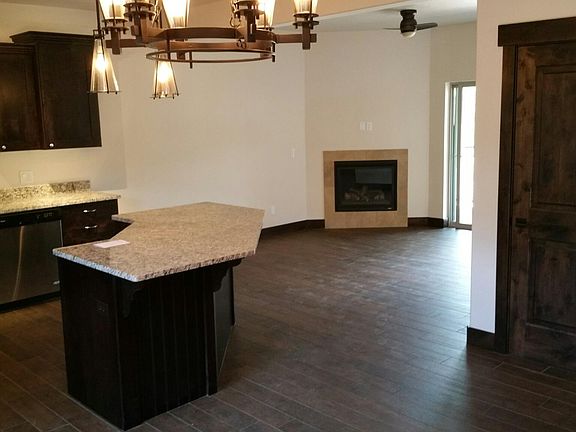 Entry way, with kitchen access, and living room with fire pl