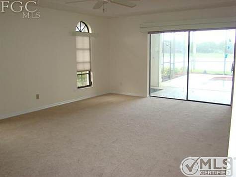 Large Master Bedroom with sliders to lanai, new carpet, tray ceilings.