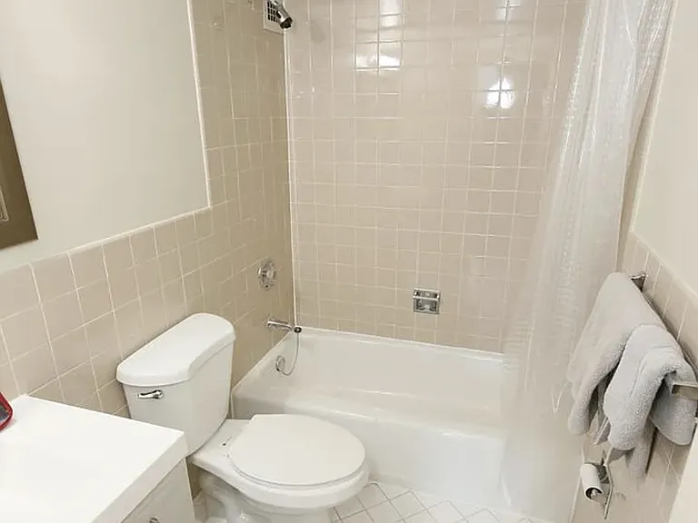 Guest bathroom with bath/shower combination. Entry is across the hallway from the second bedroom.