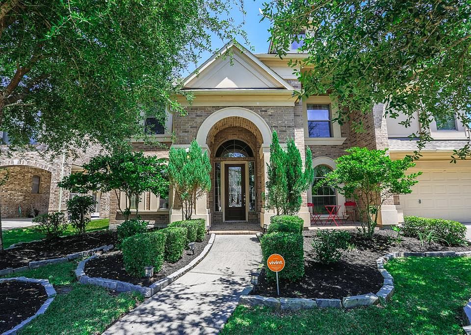 Welcoming curb appeal with landscaped yard front porch.