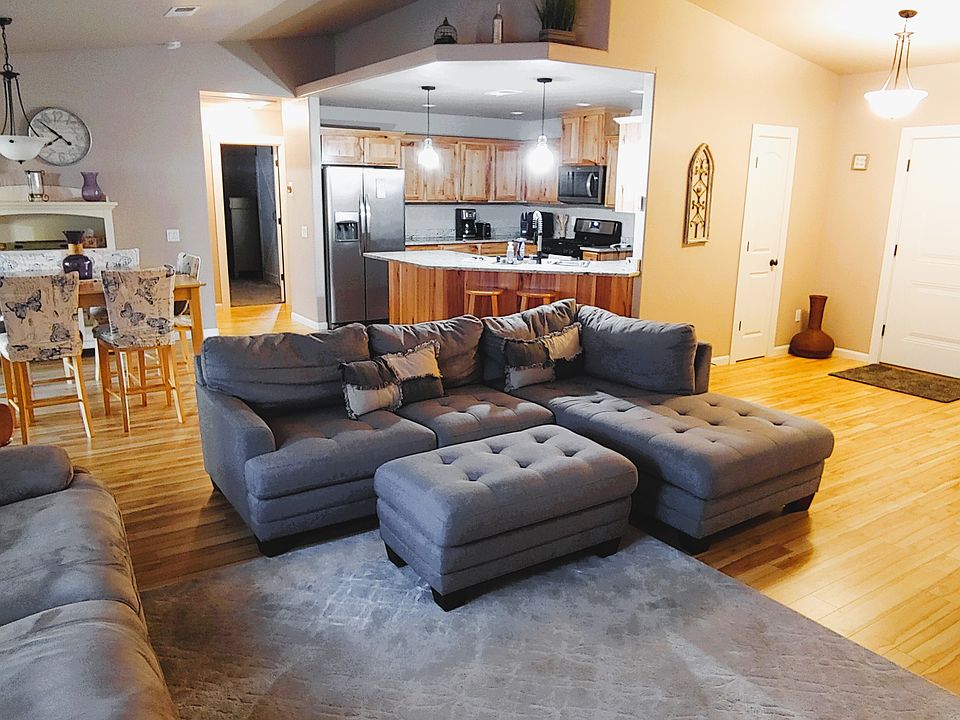 Living room with sectional sofa and dual reclining loveseat.