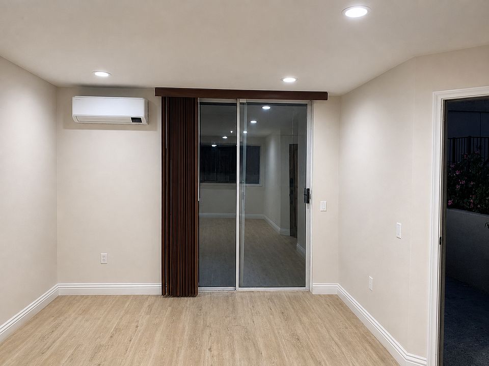 Living room (nighttime) - A/C and heating provided by Samsung mini split unit (rare in this complex), and upgraded with recessed lighting fixtures.