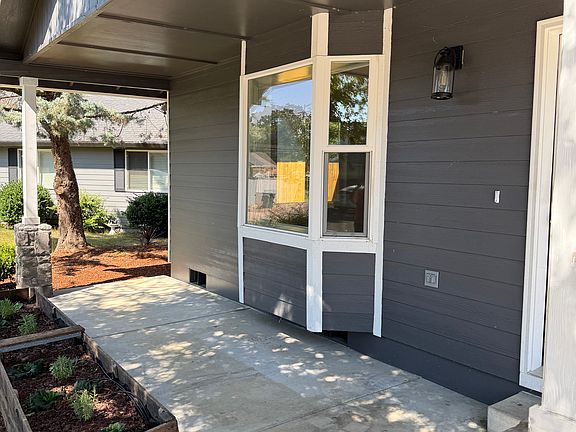 Cute covered front porch with bay window adds character and natural light. Great spot for morning coffee or greeting guests.