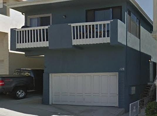Front of Building showing apartment's
 balcony and garage.