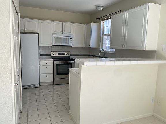 Kitchen with pantry to the left and lots of cabinets and counter space