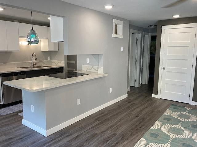 Looking into kitchen. The beautiful pendant gives resident a choice of colors & features.