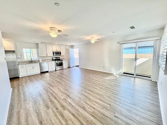 Upgraded kitchen opens to a spacious living room with balcony