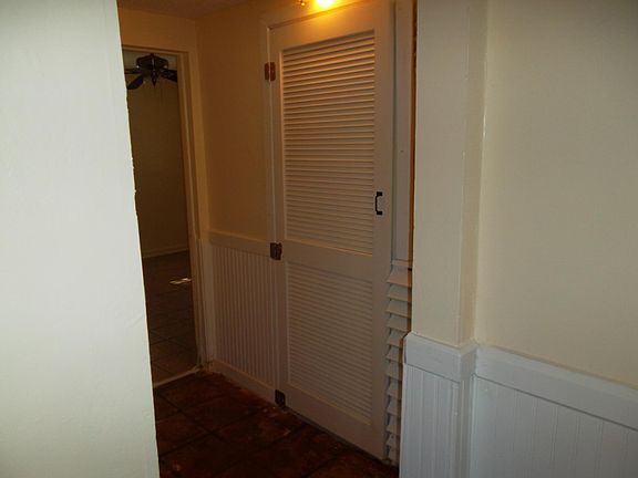 Hall showing door to main bathroom and rear bedroom