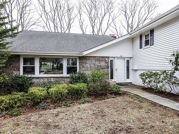 Front entry, with views from front to back through the home's oversized windows.