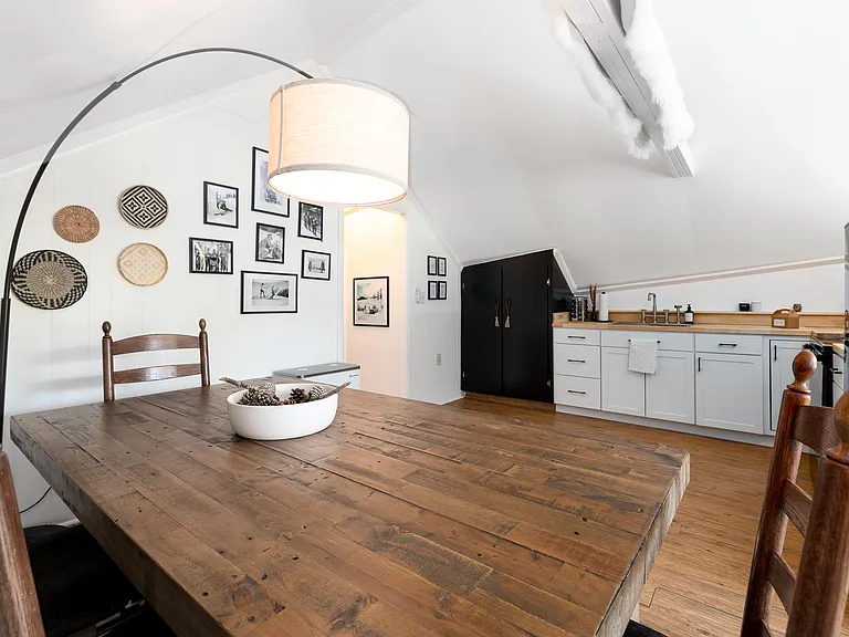 dining table looking towards ktichen and hallway to stairs that led to entry and coat closet