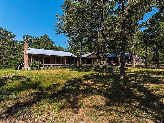 Main house with carport and guest house.