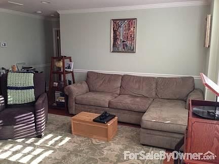 Oversized Living Room
						:
						Spacious living room; chair rail and crown molding - view from corner