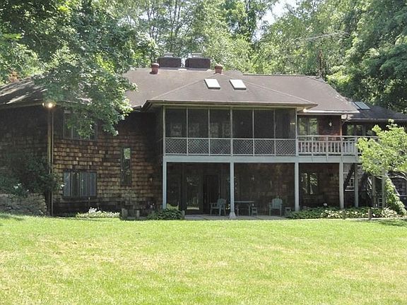 Back view of screened porch, deck, covered patio from afar