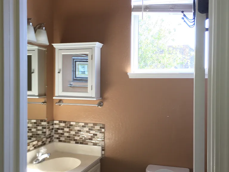 Master bathroom with two sinks, shower over tub