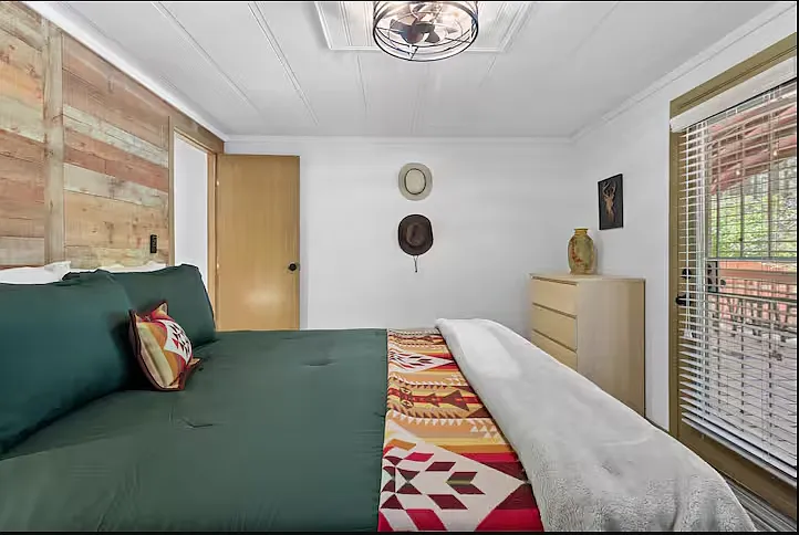 Spacious Bed with outside view.