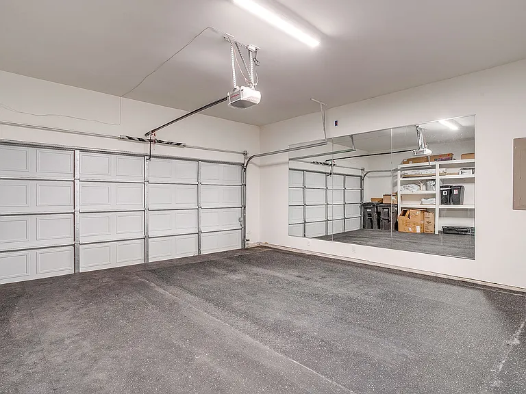 Two-car garage with exercise floor and built in storage shelves