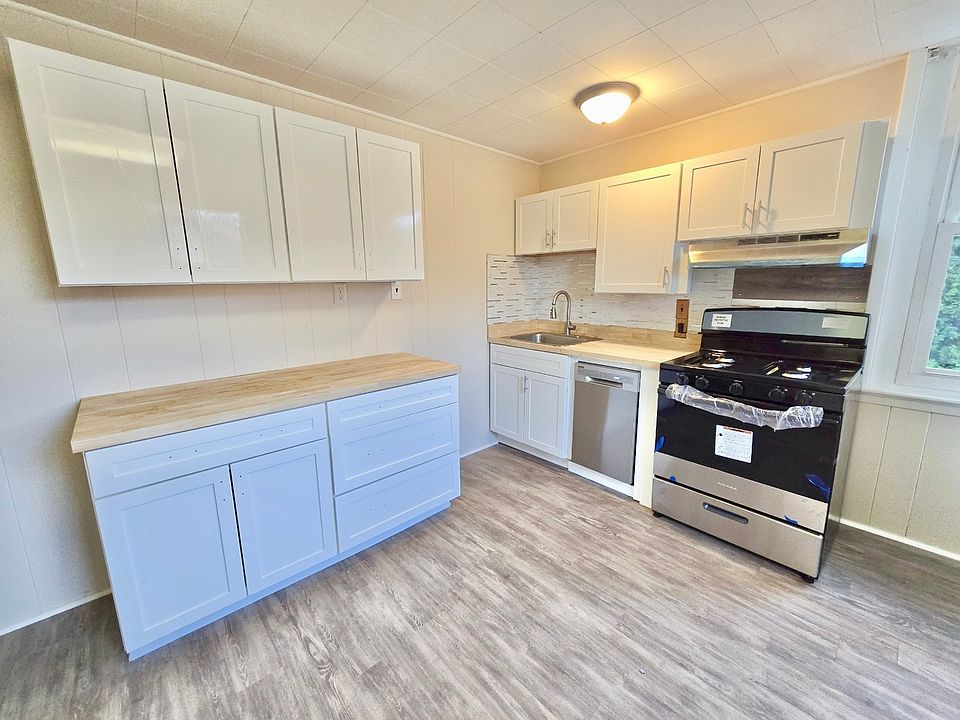 Newly rennovated kitchen with brand new cabinets, appliances, and flooring.