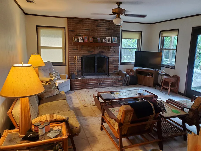 View of Family Room from kitchen. Working wood-burning fireplace
