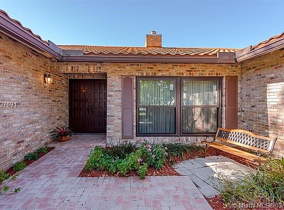 PRIVATE FRONT PORCH AND DOUBLE DOOR ENTRY