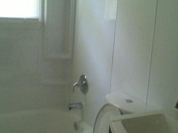Rehabbed Bathroom with dual flush toilet.