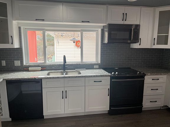 Large window in kitchen overlooking the back deck.