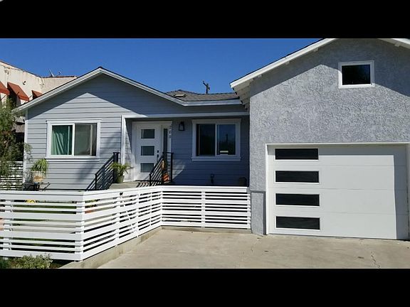 Front of house with yard, patio. and parking space.