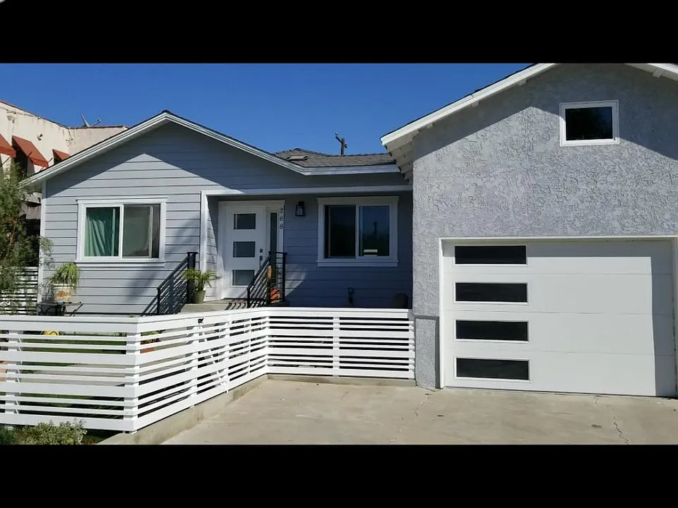 Front of house with yard, patio. and parking space.