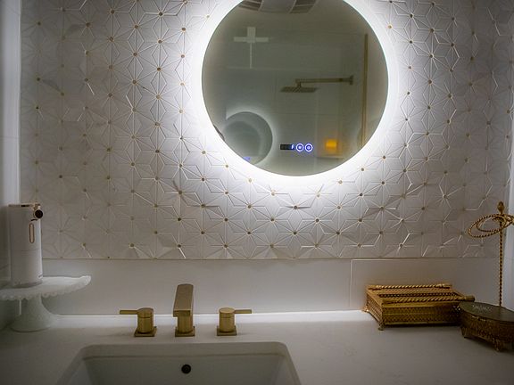 Updated second bathroom with gold mosaic accents, large tiles, and a spacious feel. Features a large vanity with gold fixtures, a relaxing rain shower head, a wide tub faucet, and an upgraded bidet toilet with automatic flush for added convenience.